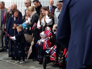 A family all dressed up and watching the parade