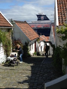 The French cruise ship peaking through Old Stavanger.