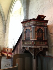 The pulpit in the chapel, ornately decorated with the Gospel evangelists on the side panels.