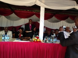 Bishop Masangwa giving gift pieces of kaky kaky