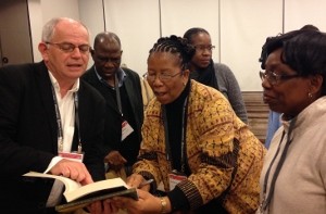Knut is showing Madipoane Masenya (center) where her work is cited in a new Proverbs commentary.