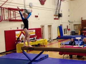 Her first balance beam routine at a gymnastics meet.