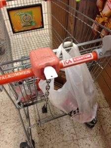 A plastic "key" unlocks the cart from the line of carts. Returning the cart means locking it back up.