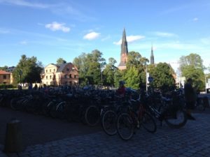 Scenes of Uppsala: bikes in front of the university library and the cathedral spire.