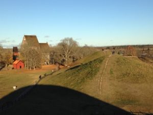 The two grave mounds seen from the top of a third mound. The old church is in the background.